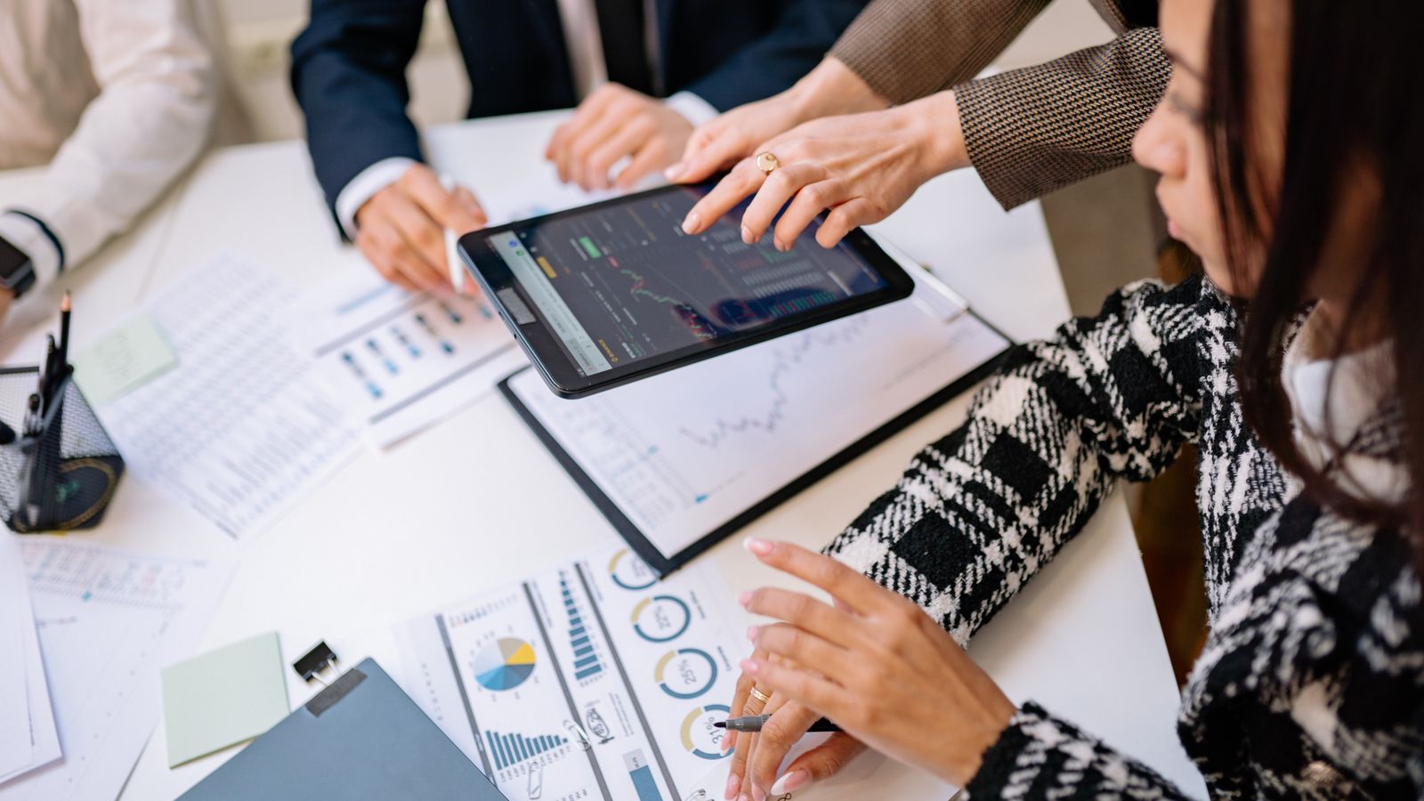 Colleagues reviewing charts and analytics on a tablet