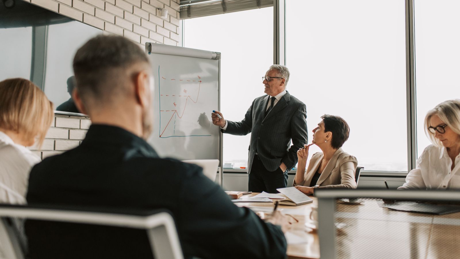 Executive presenting to colleagues in a conference room