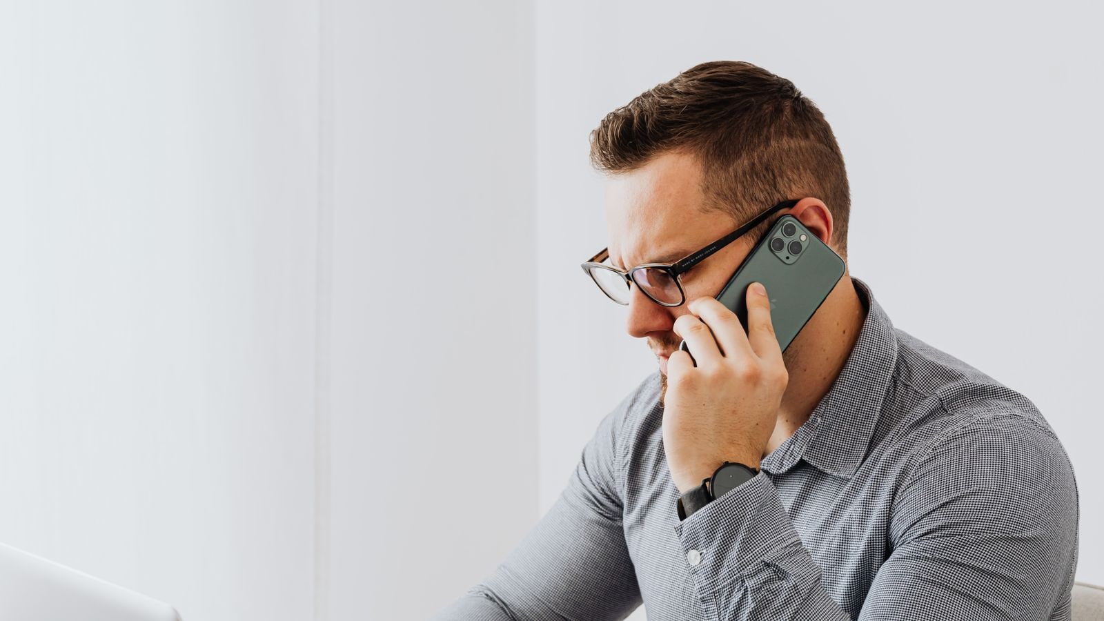 Employee on a phone call while working at a laptop